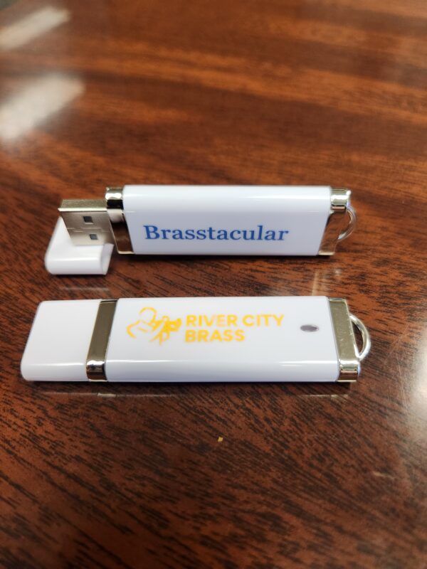 White thumb drive with blue "Brasstacular" text and gold River City Brass logo