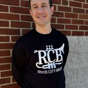 RCB Black Crewneck Sweatshirt, modeled by a member of the band in front of a brick wall
